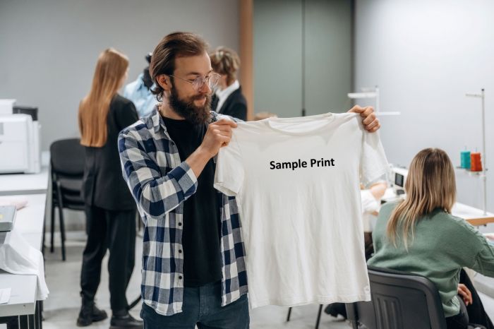 Person Holding a T Shirt - 4imPrint Competitors